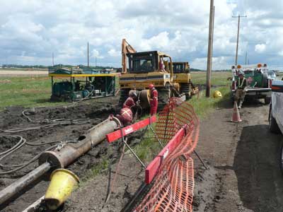 A Clean Harbors crew is extracting a 500-foot section of 8-inch steel piping with a 12-inch directional boring air pneumatic hammer.